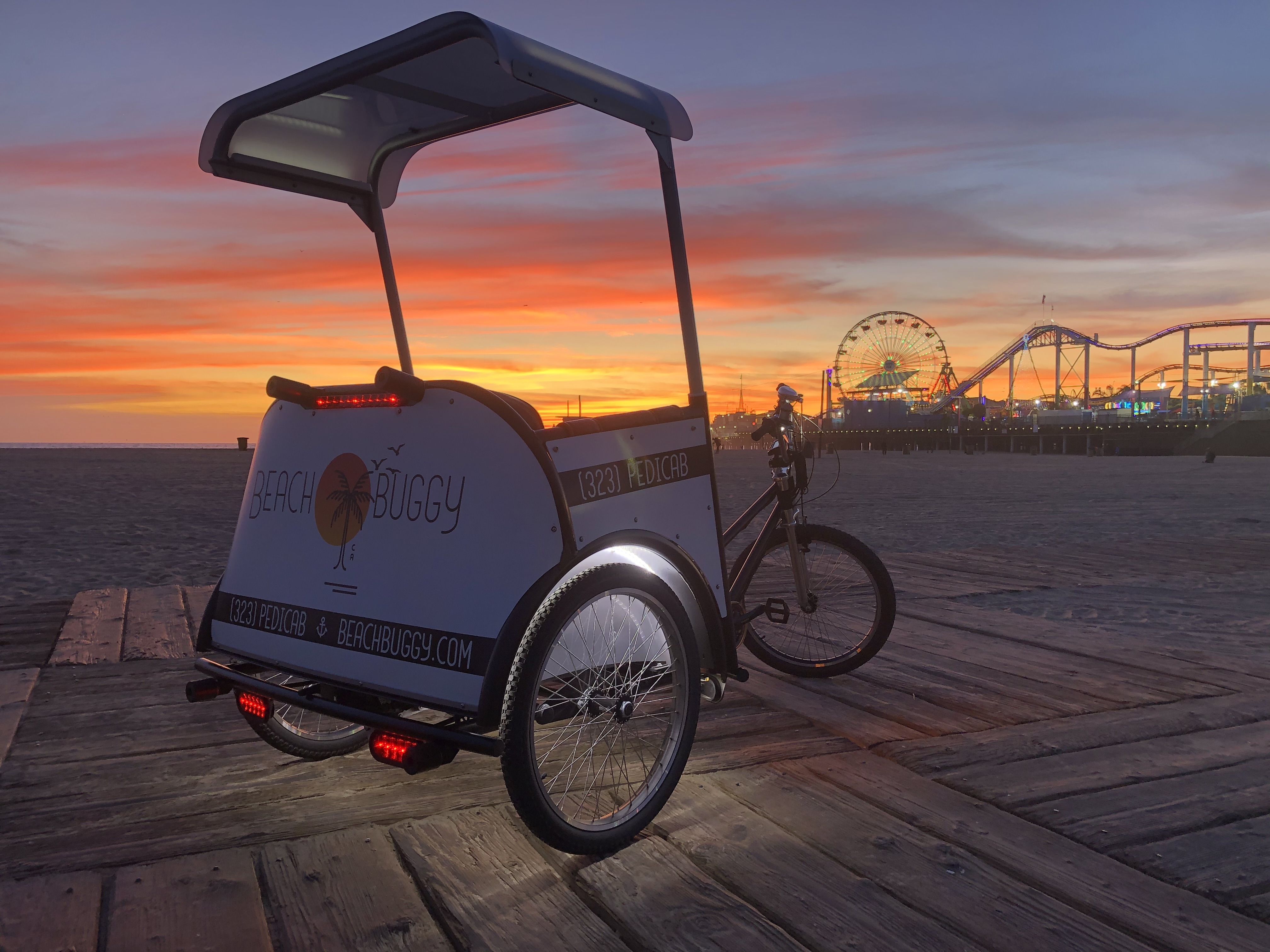 A Beach Buggy pedicab beside the Santa Monica Pier.